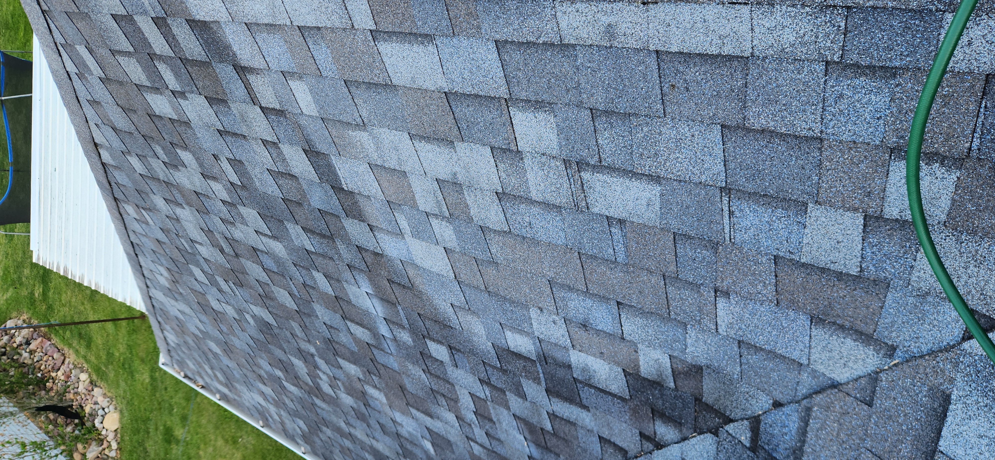 Technician applying roof rejuvenation coating